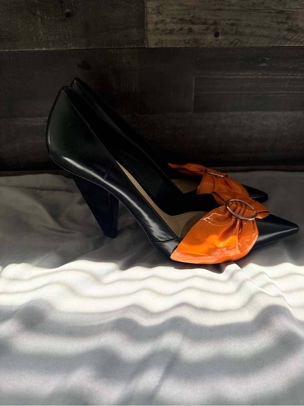 Prada Black Pointed-Toe Pumps with Orange Bow Accent